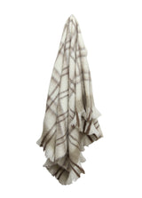taupe plaid throw with tassels  hung up