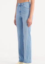high rise blue wash boot cut jeans on woman